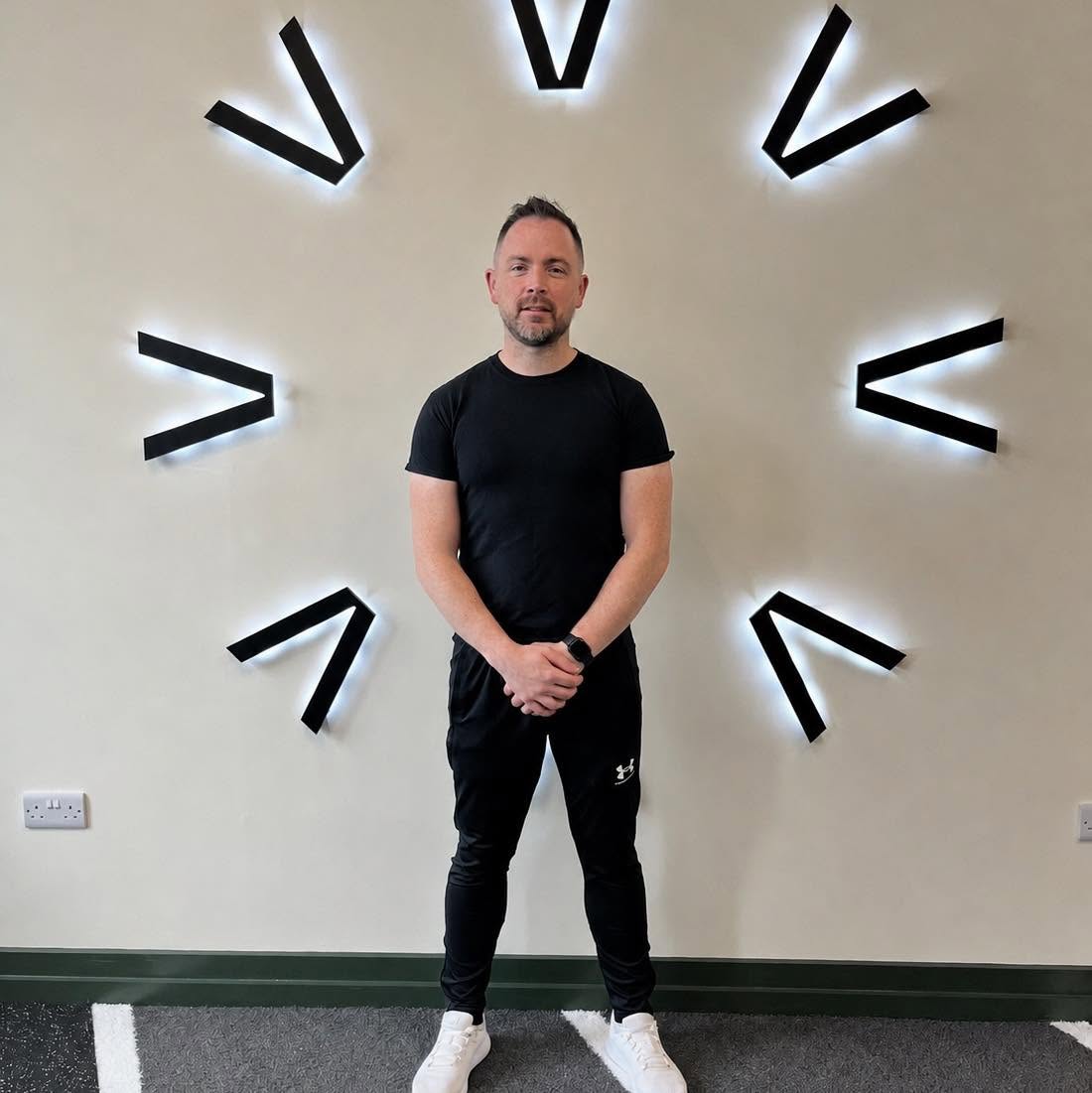 Hugh Carey, Neuromuscular Therapist, standing in his studio in Toome