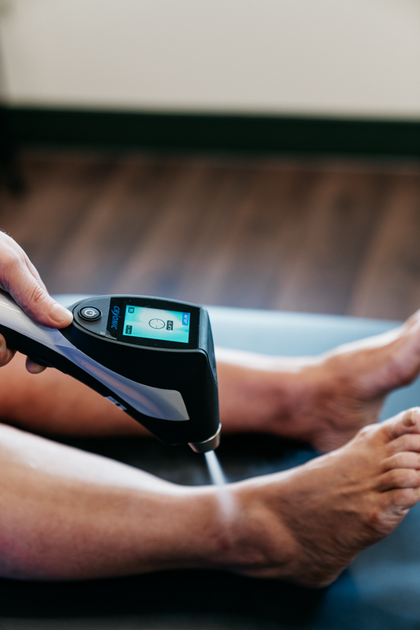 Localised CO₂ cryotherapy being applied to the ankle with a handheld device