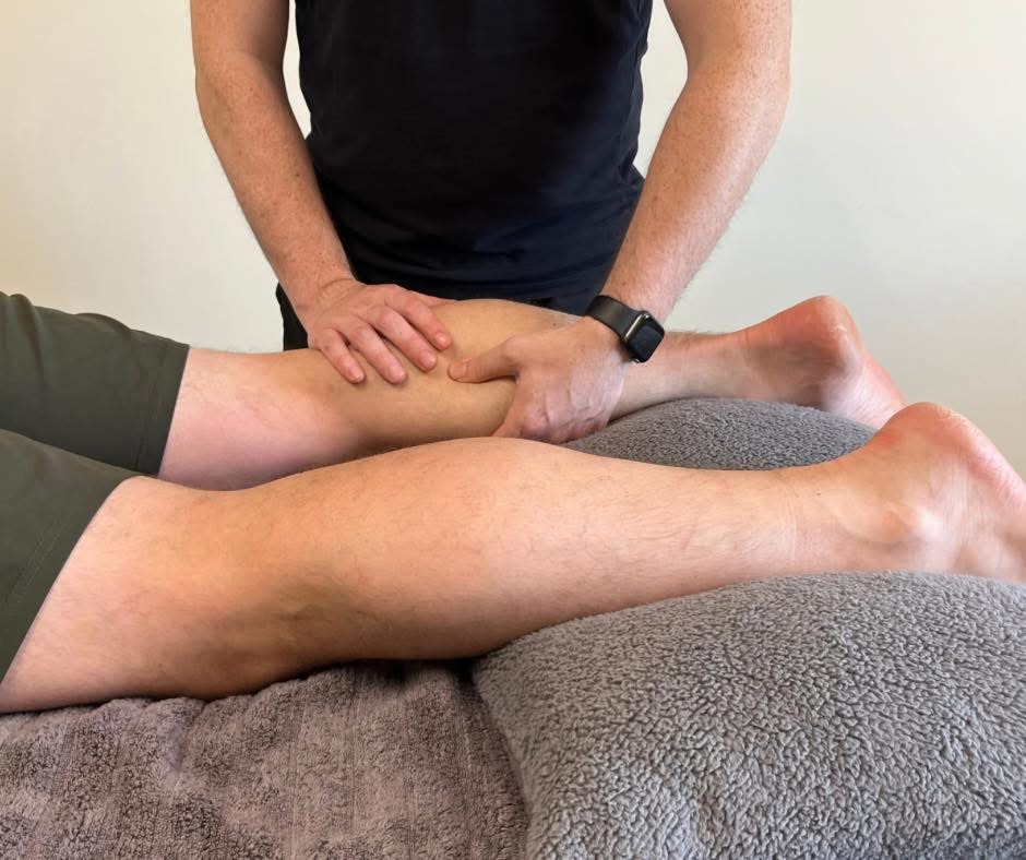 Hugh Carey applying hands-on treatment to the calf