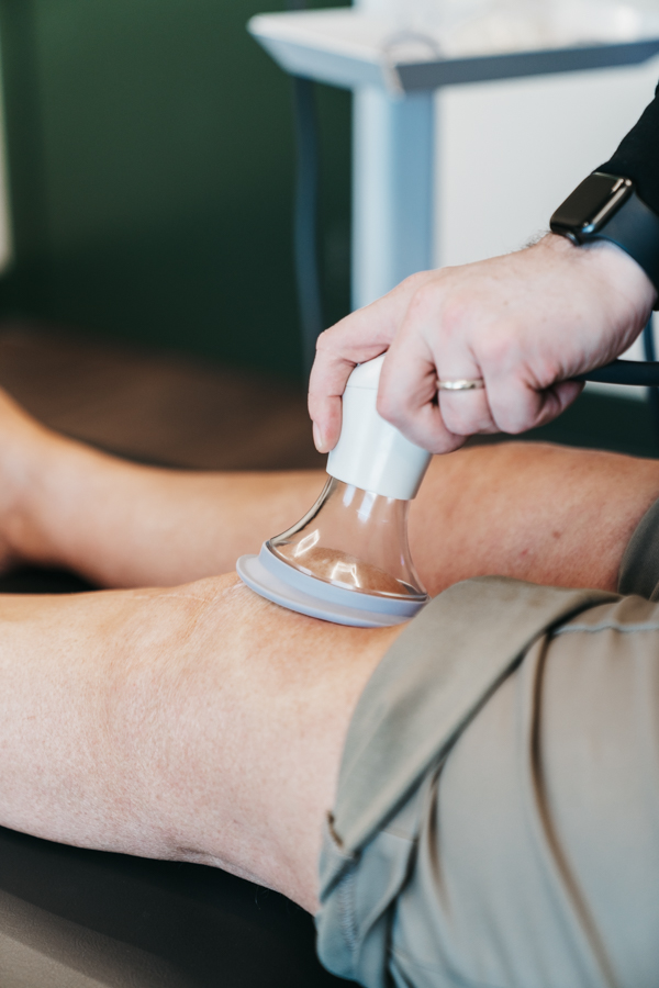 LymphaTouch negative-pressure treatment being applied above the knee